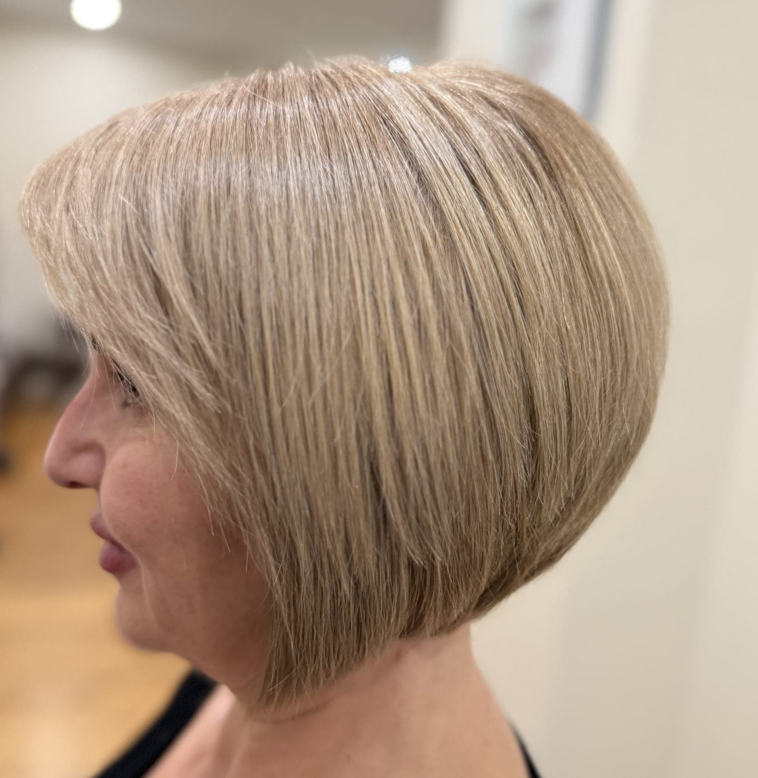 Graduated blonde bob on a mature client, seen in profile